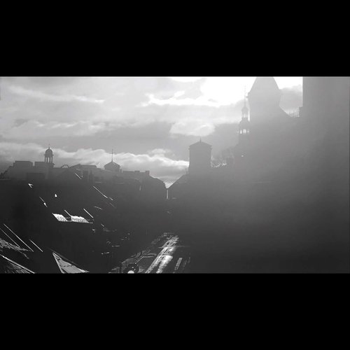 A cinematic black and white landscape of a Quebec city street